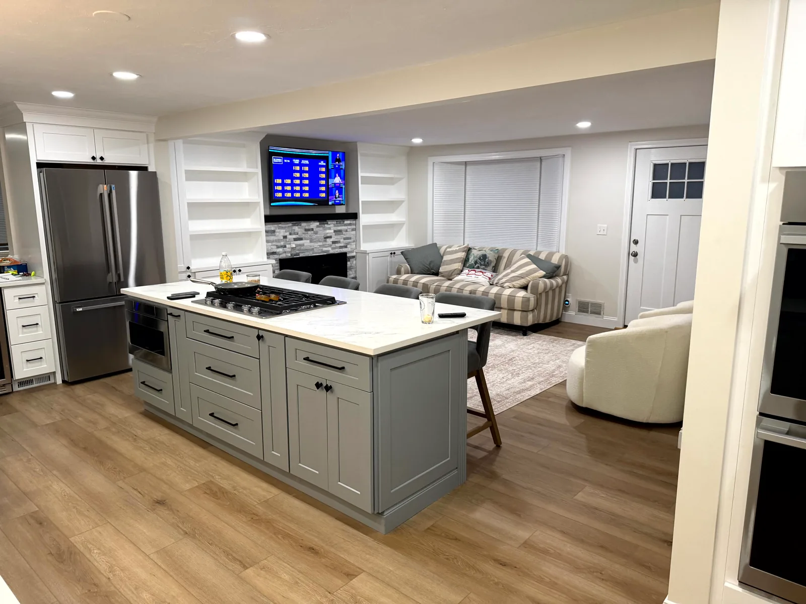 Recessed ceiling lights installed in a finished kitchen and the adjoining living room