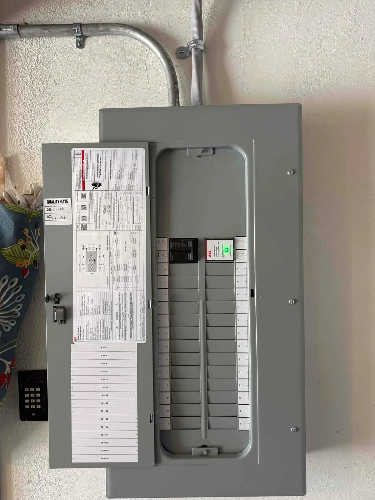 New residential electrical panel with clean conduit work and labeled EV and surge breakers